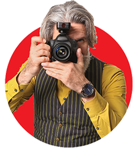 Retiree holding a professional camera up to their right eye