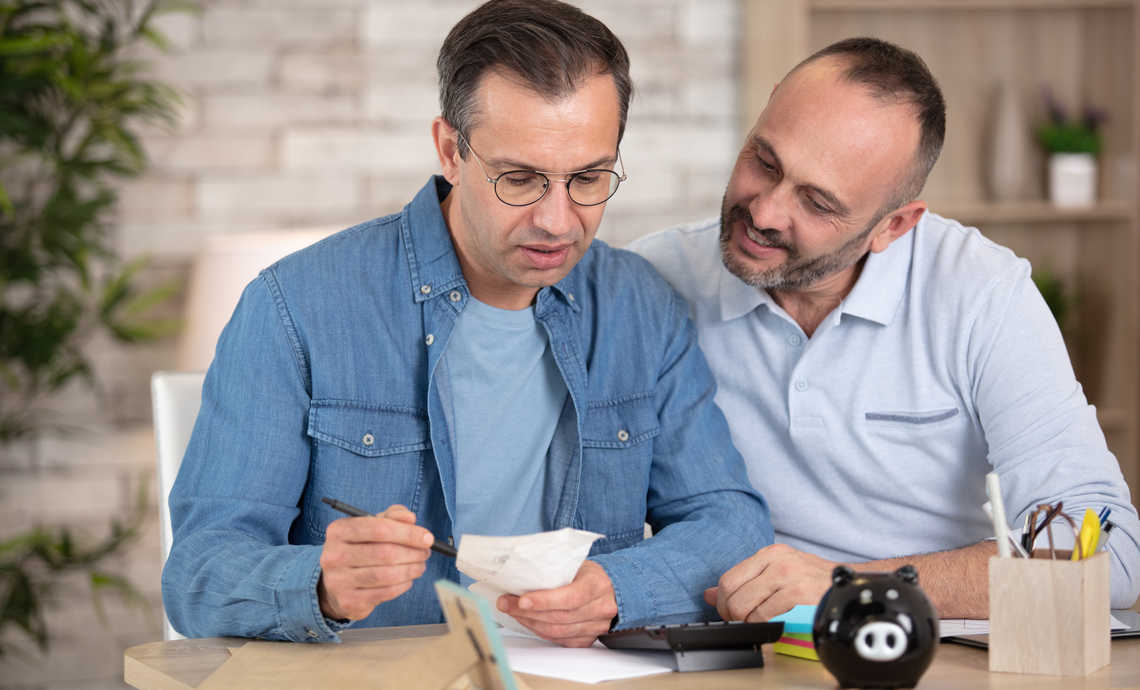 Gay couple reviewing their finances as they prepare for retirement