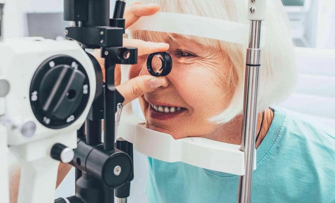Older adult looking into a eye test machine